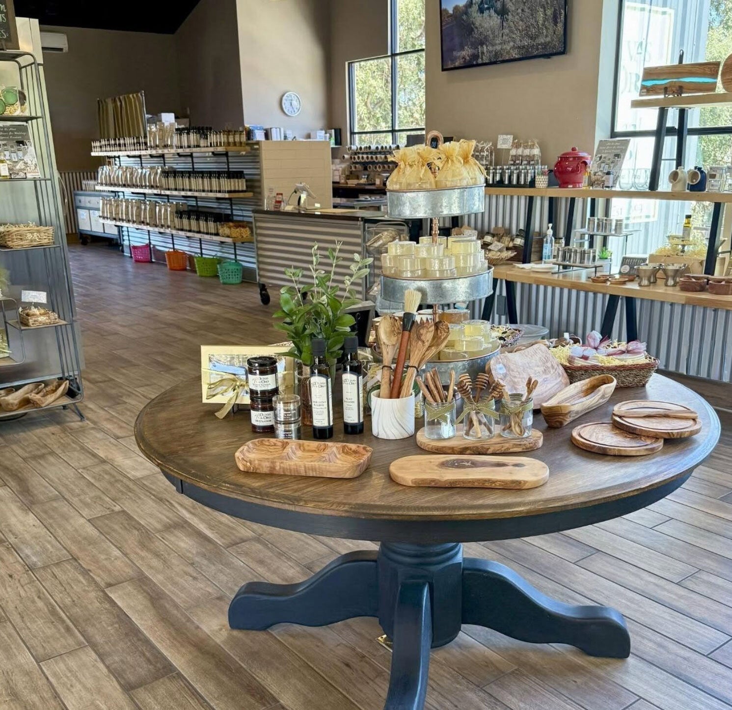 Round wooden table with various items in a store setting